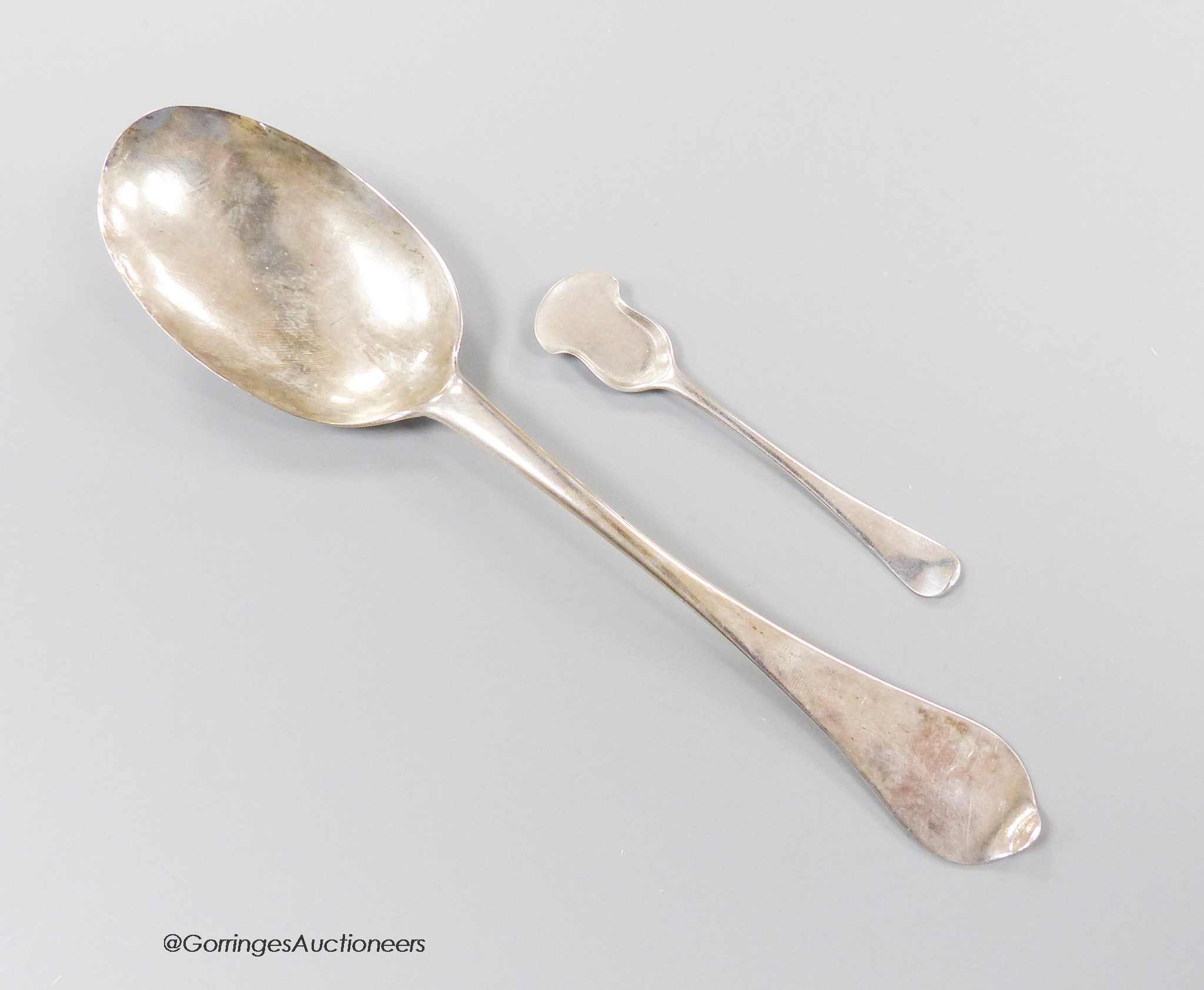 An early 18th century silver dog nose spoon, with engraved prick dot initials with date 1713, indistinct marks, 19.7cm, together with an 18th century Bristol? salt shovel, possibly Ralph Goode, c.1735, gross 46 grams.